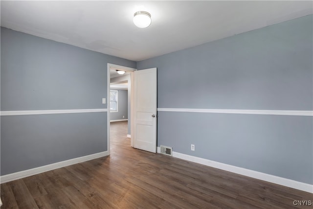 spare room featuring dark hardwood / wood-style flooring