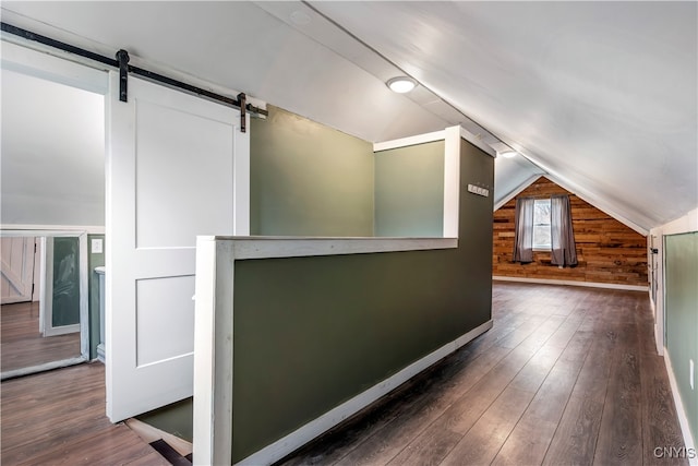 bonus room featuring dark hardwood / wood-style flooring, wooden walls, and vaulted ceiling