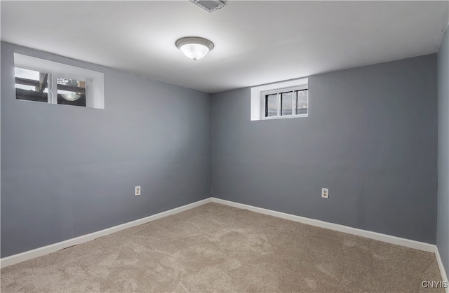 basement featuring light colored carpet