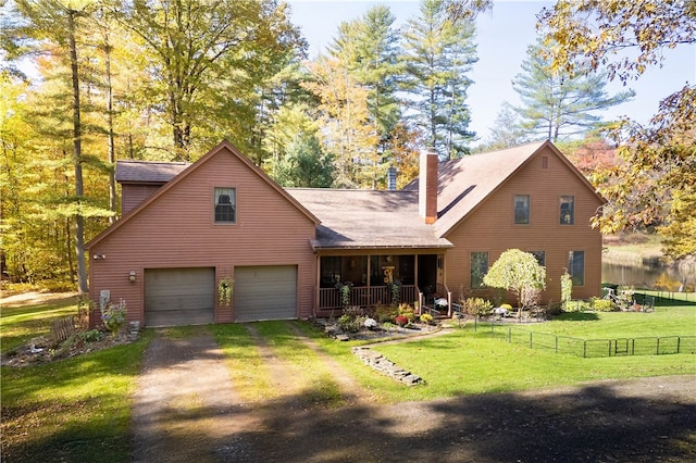 view of front facade with covered porch, a garage, and a front yard