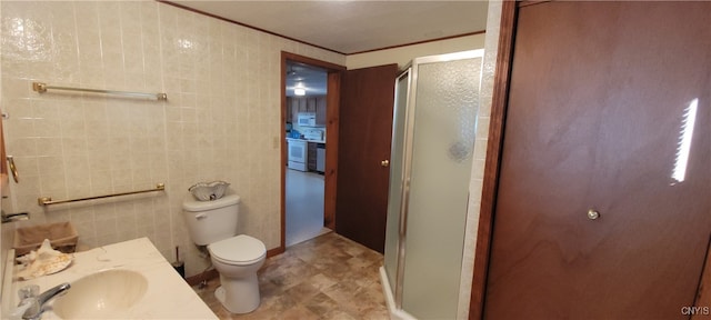 bathroom featuring tile walls, walk in shower, toilet, and sink