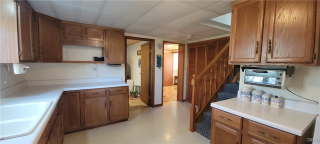 kitchen featuring a paneled ceiling and sink