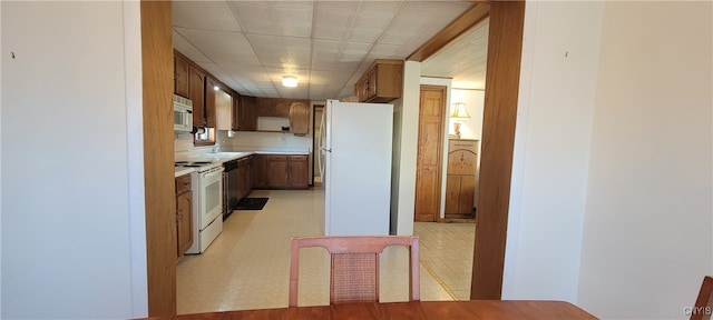 kitchen with sink and white appliances