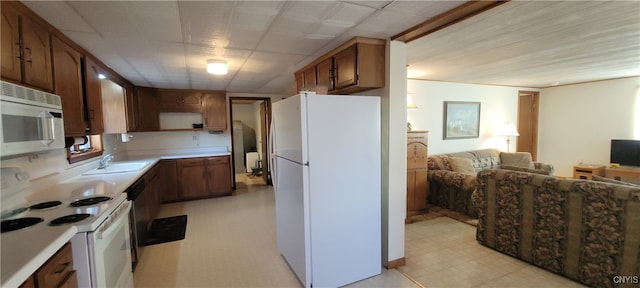 kitchen featuring white appliances and sink