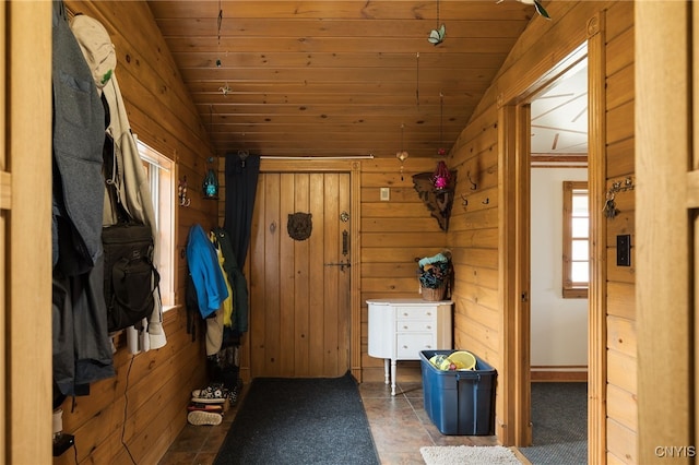 mudroom with wood walls, wood ceiling, and vaulted ceiling