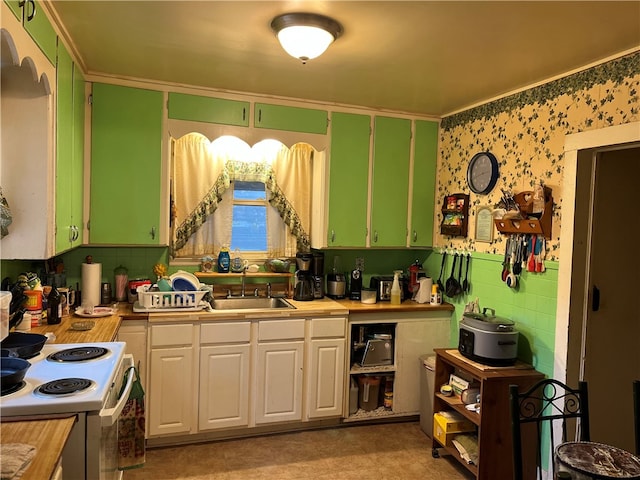 kitchen with electric stove, sink, crown molding, and white cabinets