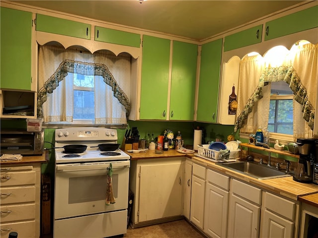 kitchen with sink, white cabinetry, and white electric range