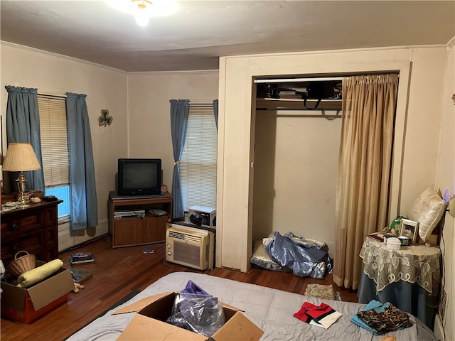 bedroom featuring wood-type flooring and ornamental molding