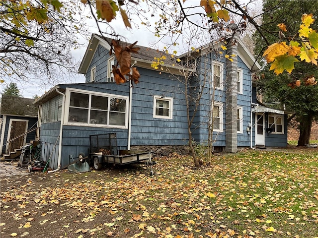 rear view of house featuring a sunroom