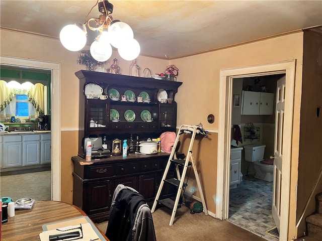 dining area with a notable chandelier and crown molding