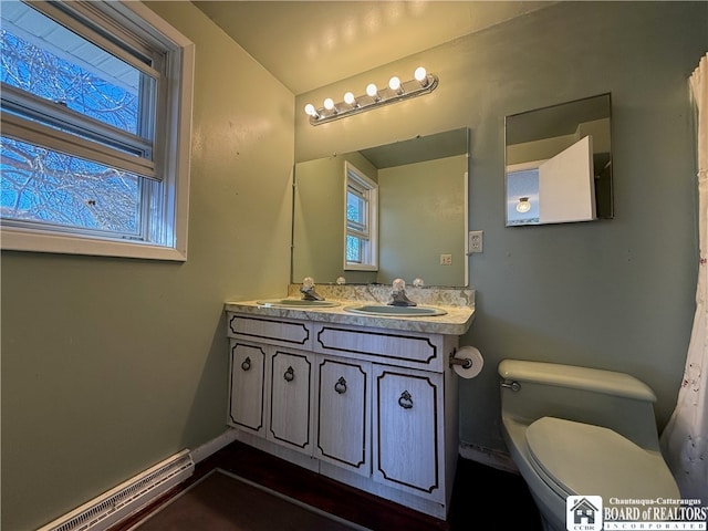 bathroom with a baseboard radiator, vanity, and toilet