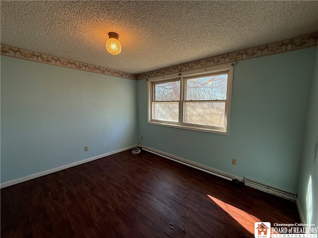 unfurnished room with dark hardwood / wood-style flooring and a textured ceiling