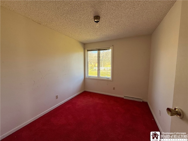 carpeted empty room featuring a textured ceiling