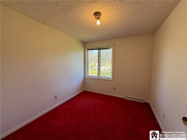 unfurnished room featuring a textured ceiling and carpet