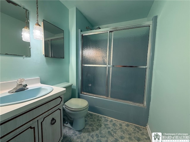 full bathroom featuring toilet, combined bath / shower with glass door, and vanity