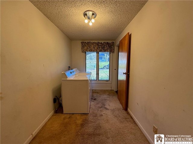 washroom featuring washer and clothes dryer, a textured ceiling, and light colored carpet