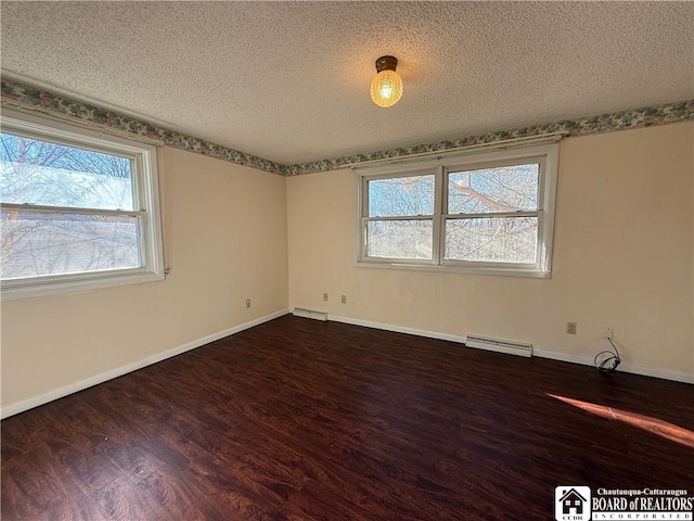 unfurnished room with a baseboard radiator, hardwood / wood-style floors, and a textured ceiling