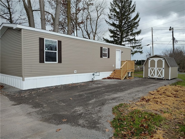 view of side of property featuring a storage unit