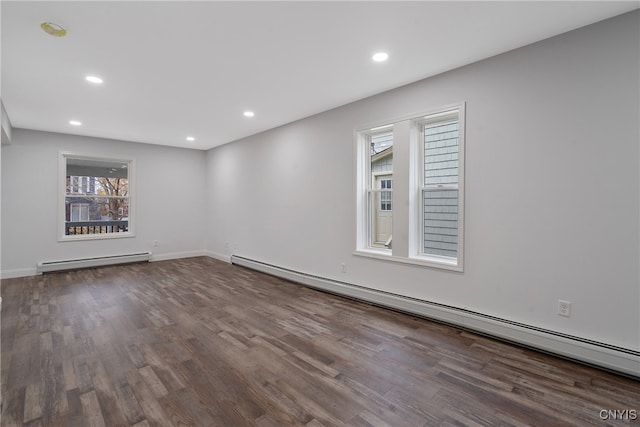 unfurnished room featuring a baseboard radiator and wood-type flooring