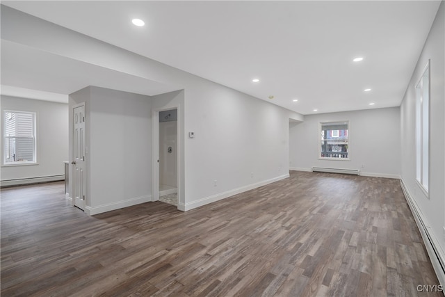 unfurnished living room with a baseboard radiator and dark hardwood / wood-style floors