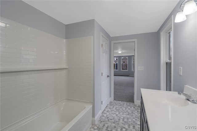 bathroom featuring a bathing tub, vanity, and tile patterned floors