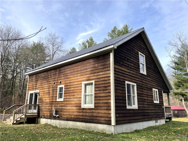 view of side of home with a lawn