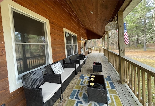 deck featuring covered porch and an outdoor hangout area