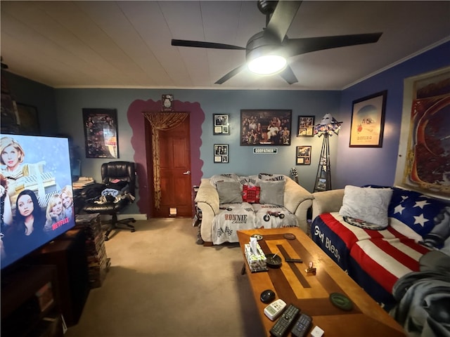 carpeted living room featuring ceiling fan and ornamental molding