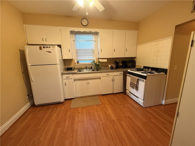 kitchen with white appliances, decorative backsplash, light hardwood / wood-style floors, and white cabinets