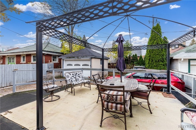 view of patio / terrace with a garage and an outdoor structure