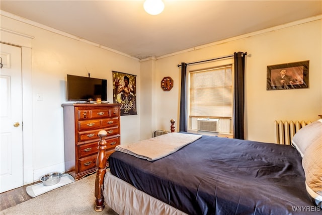 bedroom featuring hardwood / wood-style flooring, cooling unit, radiator heating unit, and crown molding