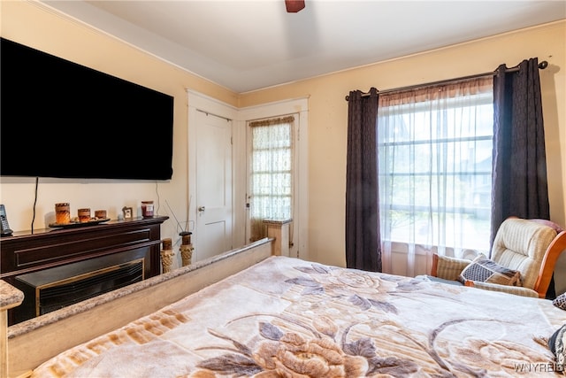 bedroom with multiple windows and ceiling fan