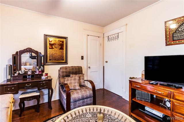 sitting room with dark hardwood / wood-style floors and crown molding