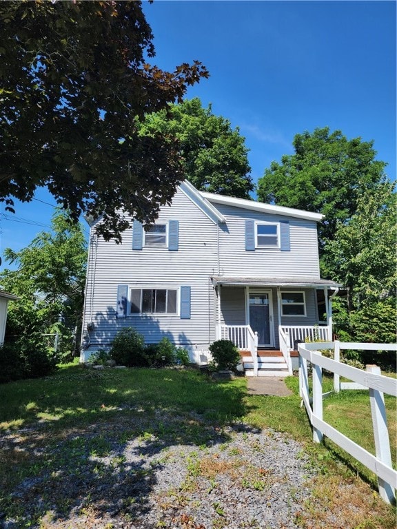 view of front facade with a porch and a front lawn