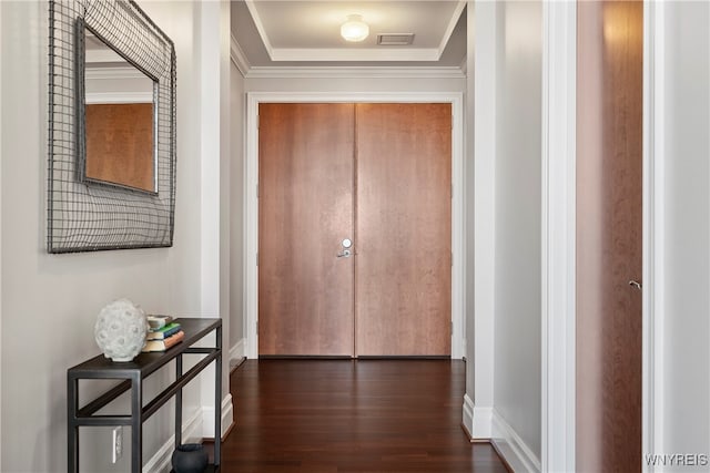 hall with dark hardwood / wood-style flooring and crown molding