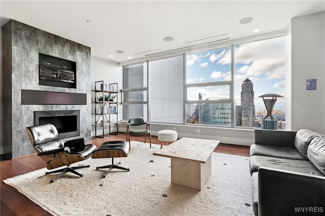 living room with a wealth of natural light, hardwood / wood-style floors, and a fireplace