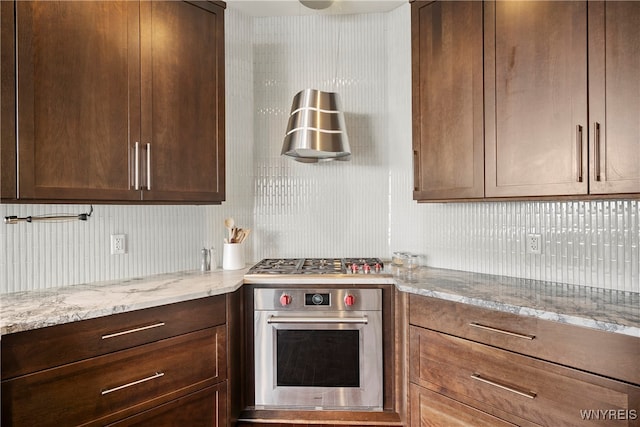 kitchen with light stone countertops and stainless steel appliances