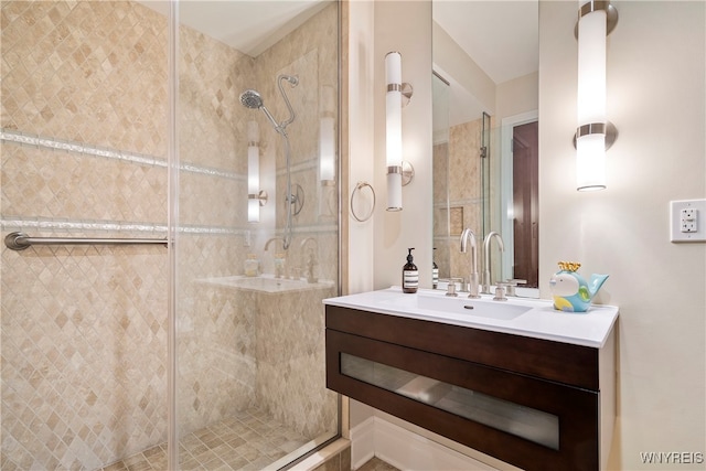 bathroom with vanity and a shower with shower door