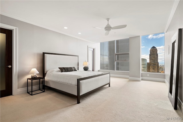 bedroom featuring ornamental molding, light colored carpet, and ceiling fan