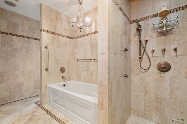 bathroom with an inviting chandelier and separate shower and tub