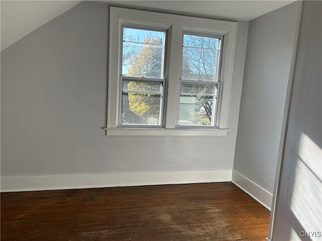 additional living space featuring dark hardwood / wood-style flooring and vaulted ceiling