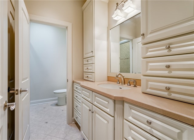 bathroom with vanity, tile patterned flooring, and toilet