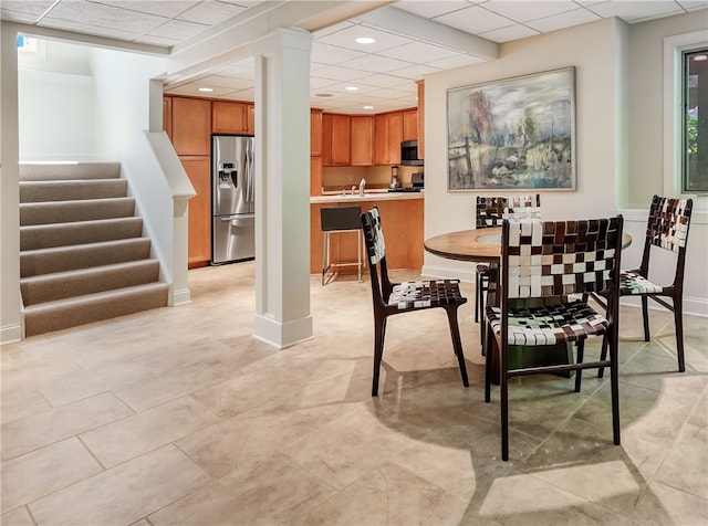 dining room featuring a paneled ceiling and sink