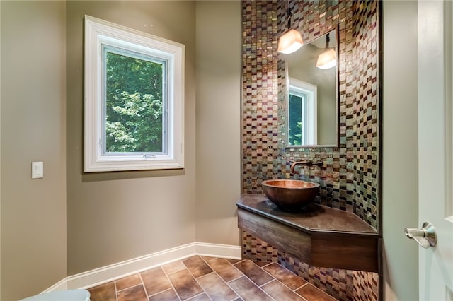 bathroom with vanity, tile patterned flooring, and backsplash