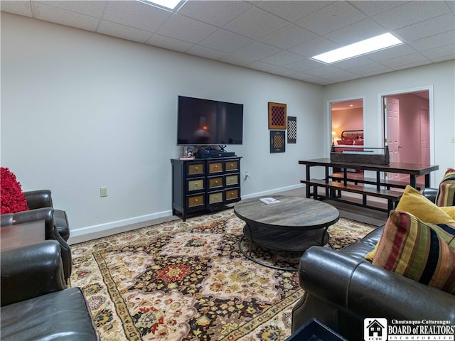 living room with a drop ceiling