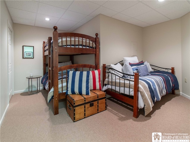 bedroom featuring carpet floors and a drop ceiling