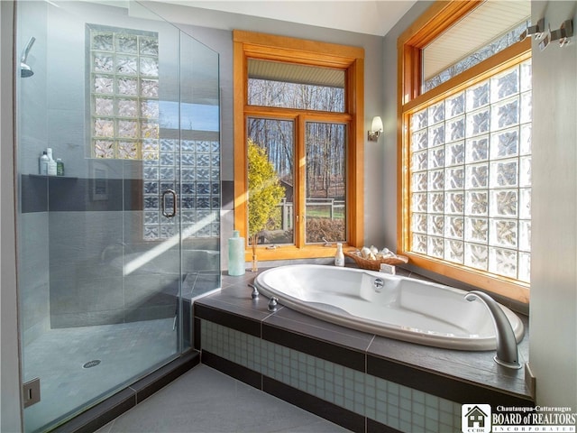 bathroom featuring plenty of natural light and plus walk in shower