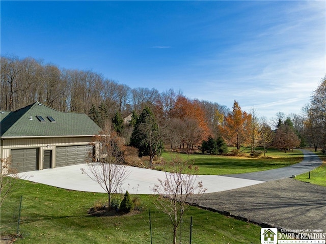 exterior space featuring a garage and a lawn