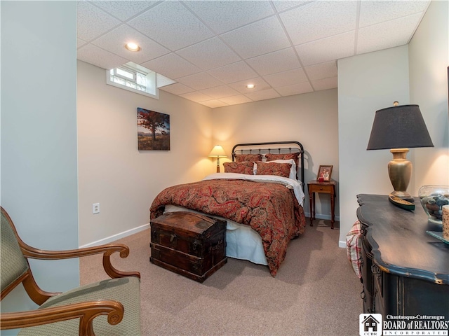 bedroom with a paneled ceiling and carpet floors