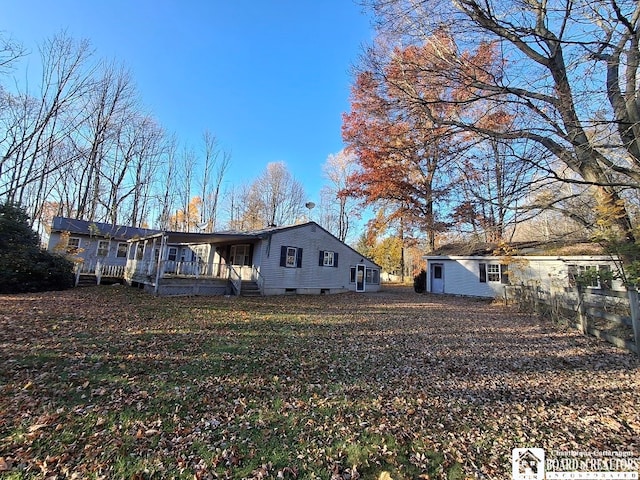 back of property with a porch